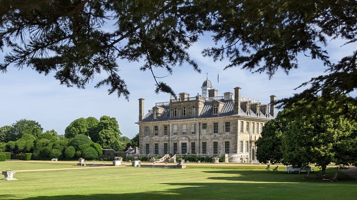 The ornate stone mansion at Kingston Lacy, Dorset, surrounded by lawns.